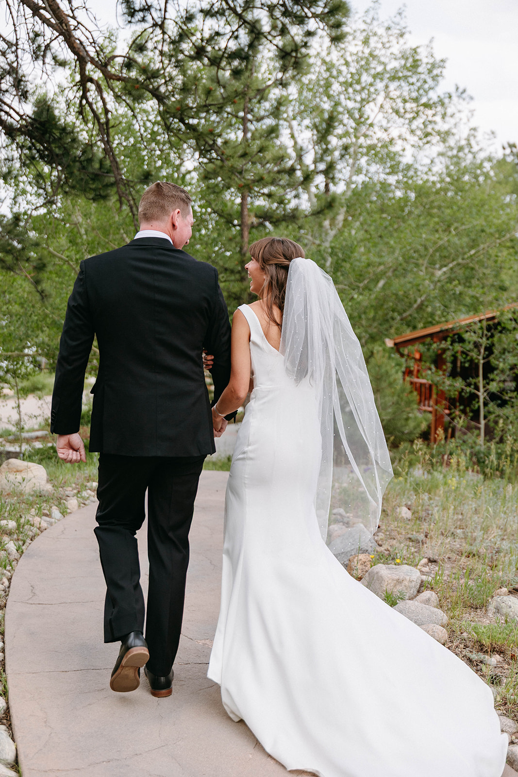 Jason and Amy kissing on the rocks framed by aspen trees